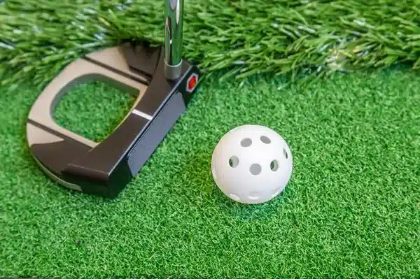 Longridge Airflow golf balls with a putter on a putting mat.