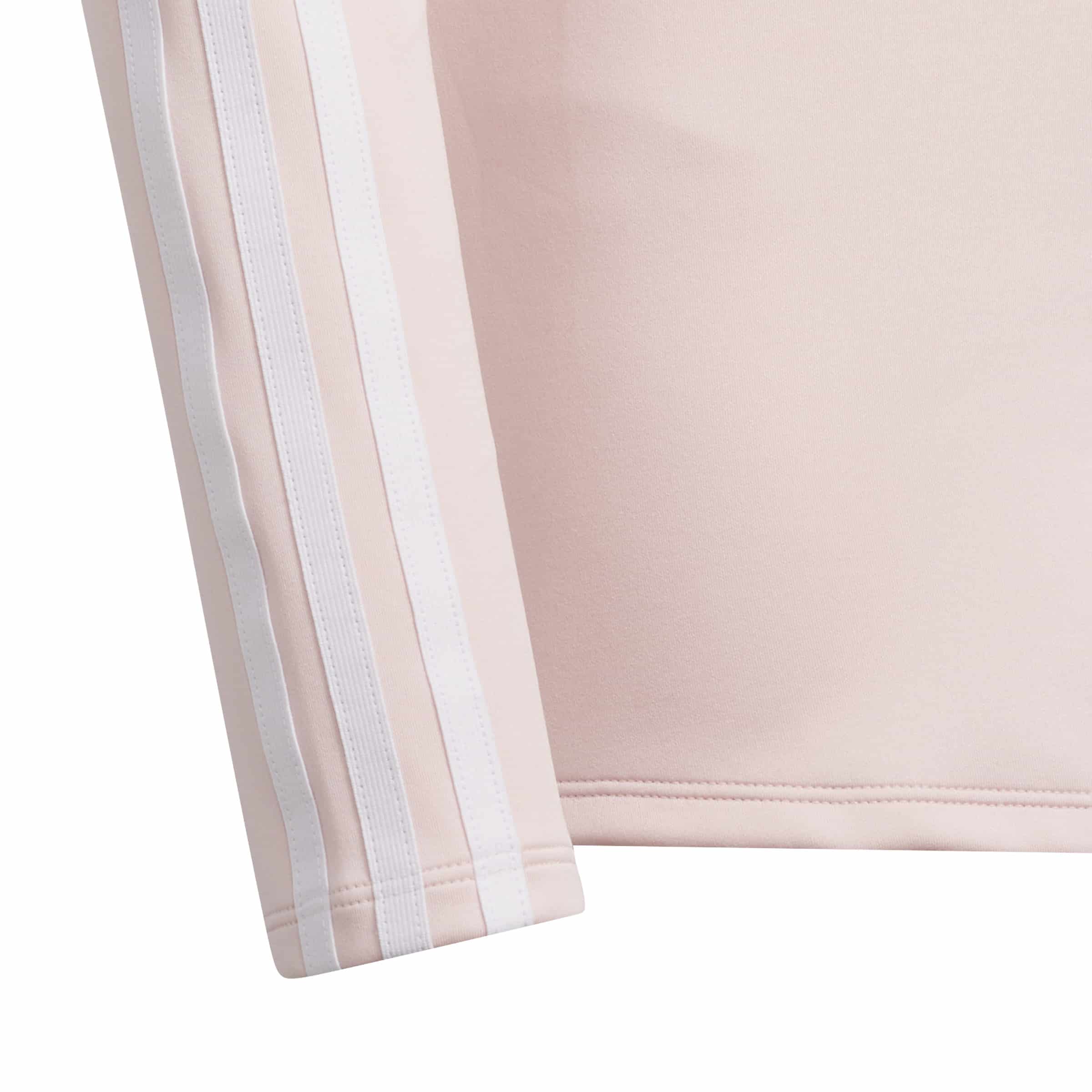 close up showing the pink and white contrast 3 stripes on the arms, signifying the subtle adidas branding.