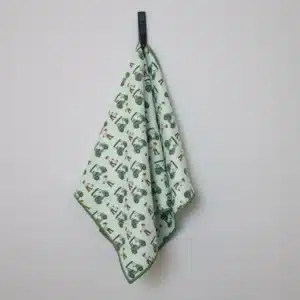 Picture of a green golf towel featuring mini golf carts to create a funk design, against a white background.