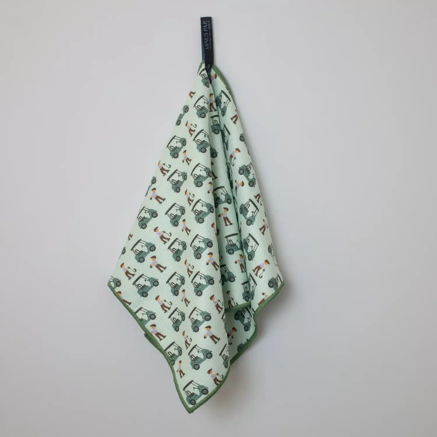 Picture of a green golf towel featuring mini golf carts to create a funk design, against a white background.