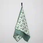Picture of a green golf towel featuring mini golf carts to create a funk design, against a white background.
